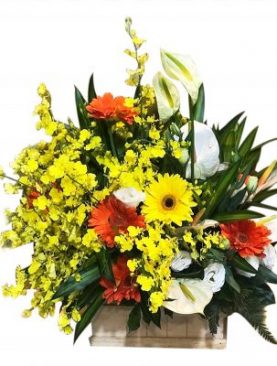 A Mix of vibrant blooms inside a bamboo basket