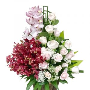 A basket of Pink Roses And Orchid