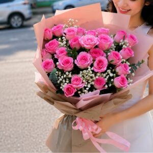 Young woman holding a large bouquet of fresh pink roses wrapped in elegant floral paper